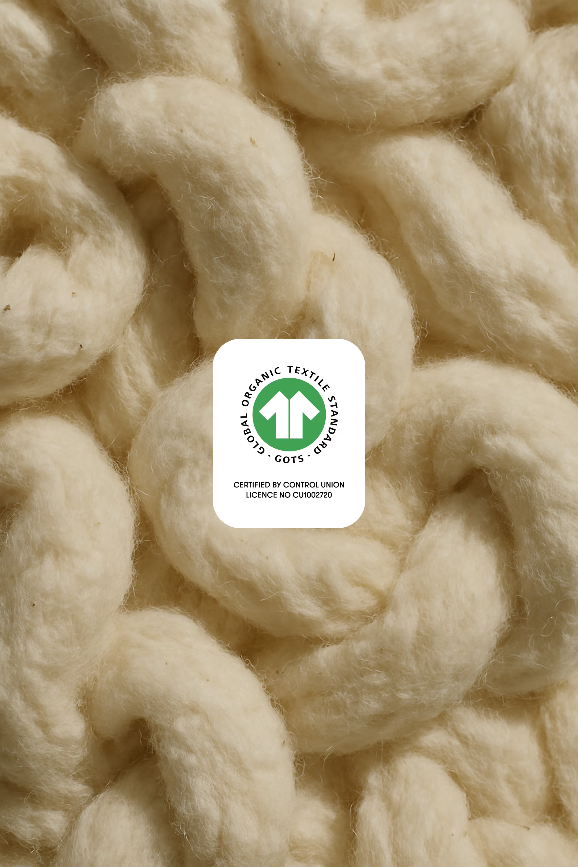 Close-up of beige knitted fabric with a visible label.